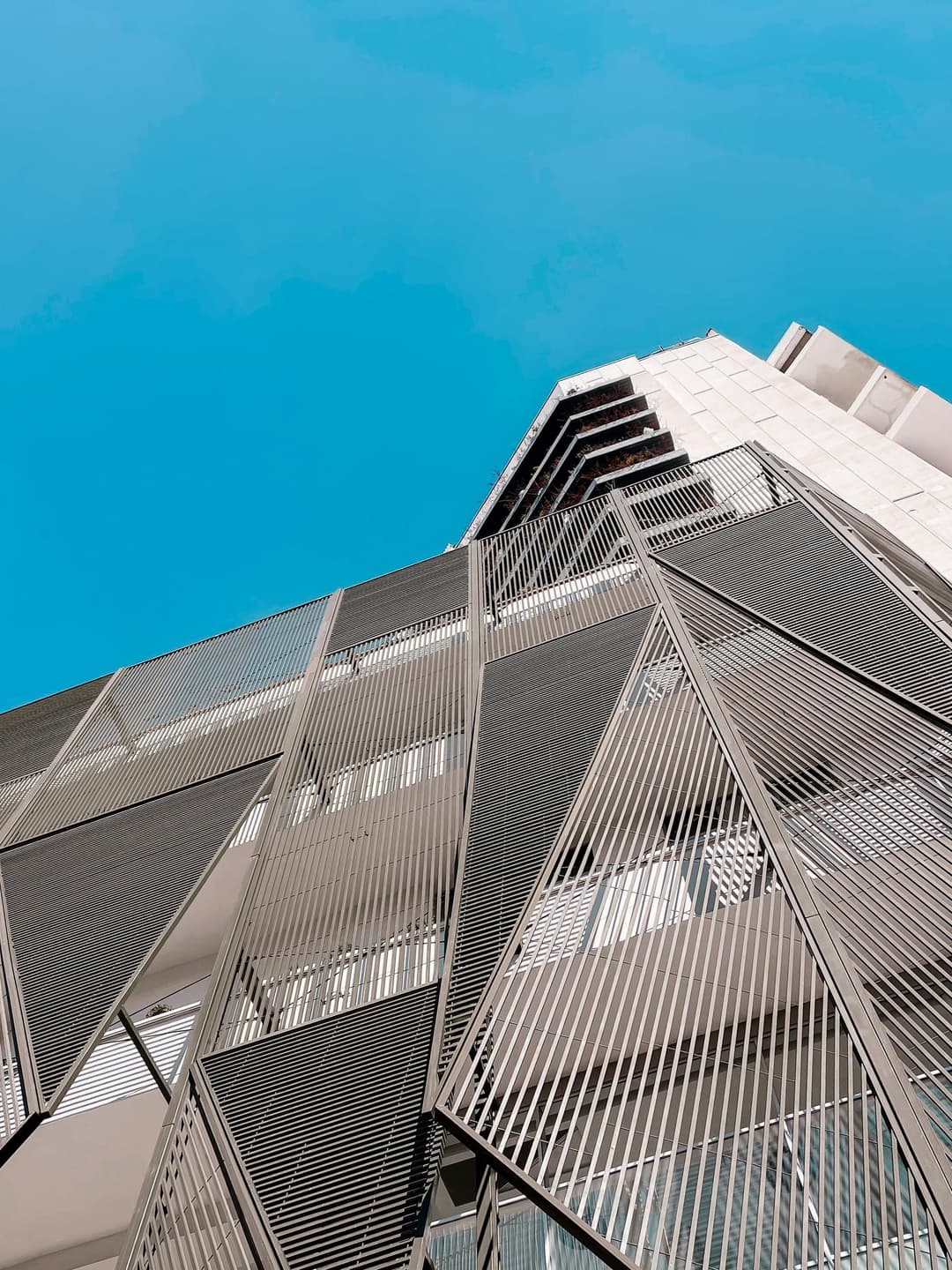 Angular modern building facade against blue sky
